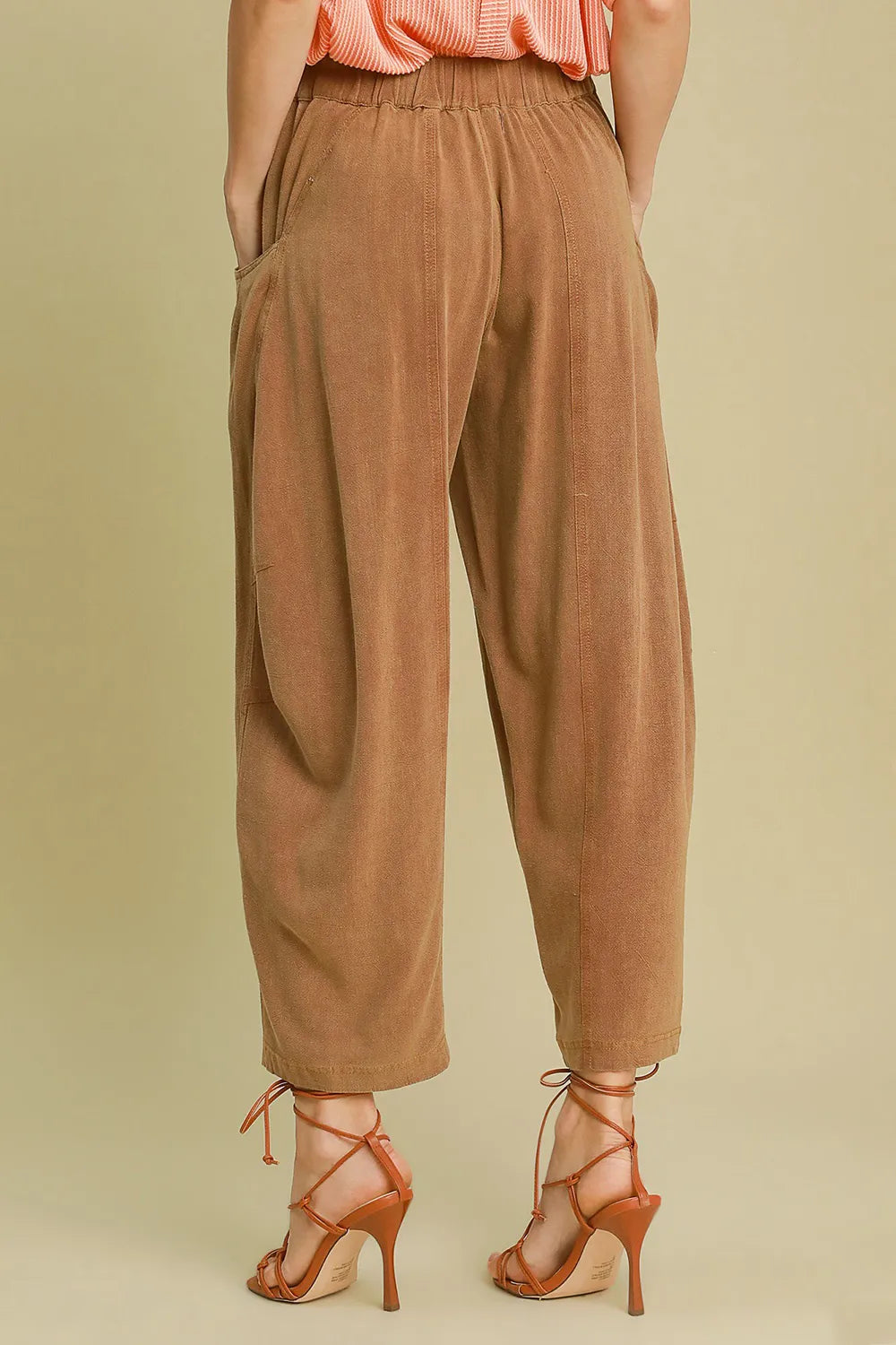Close-up of sheer linen blend pants showing pocket detail