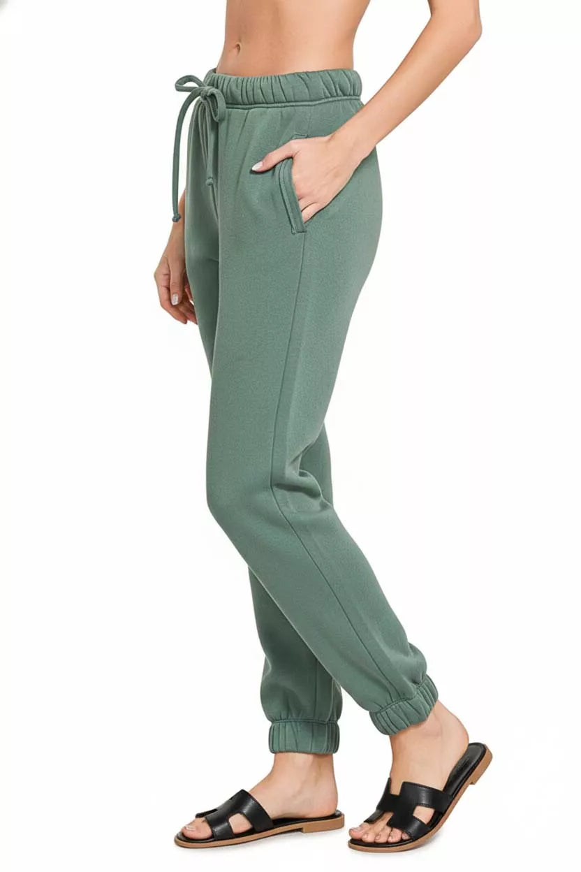 Fleece joggers in ash jade green showcasing relaxed fit and texture