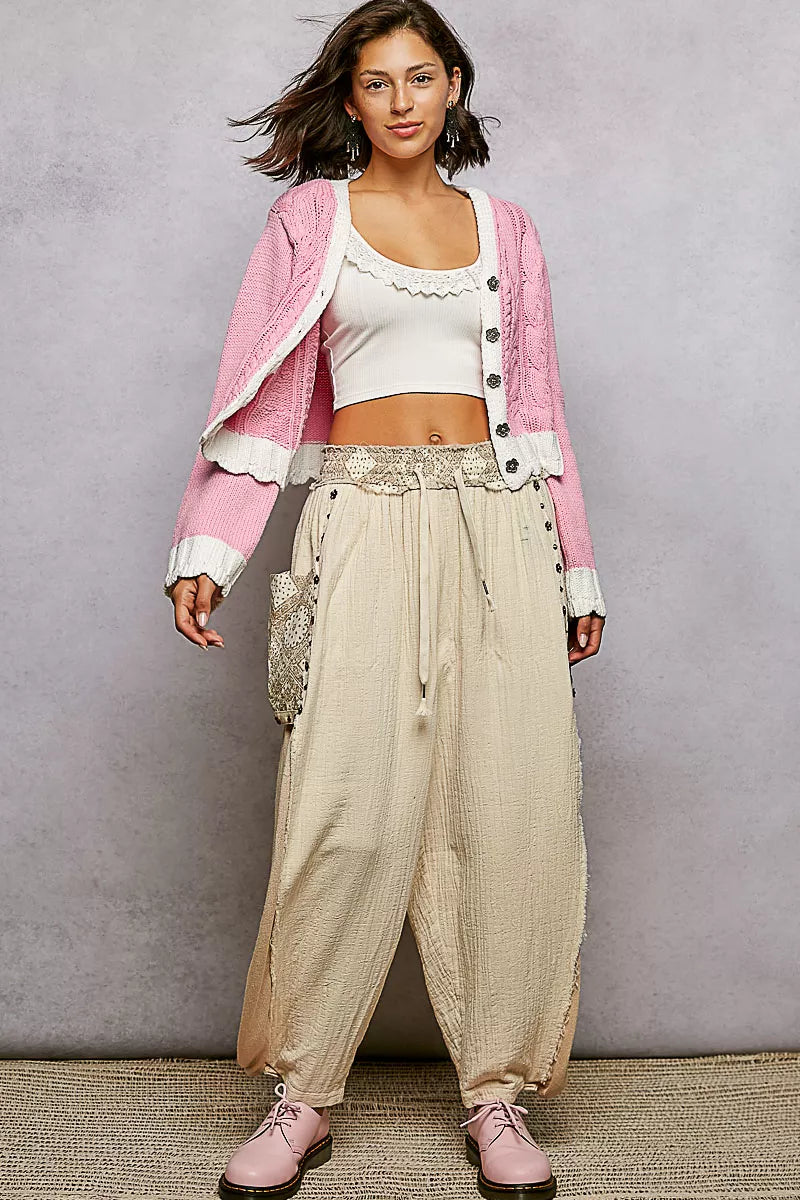 Pink cardigan showcasing contrast border and buttoned front