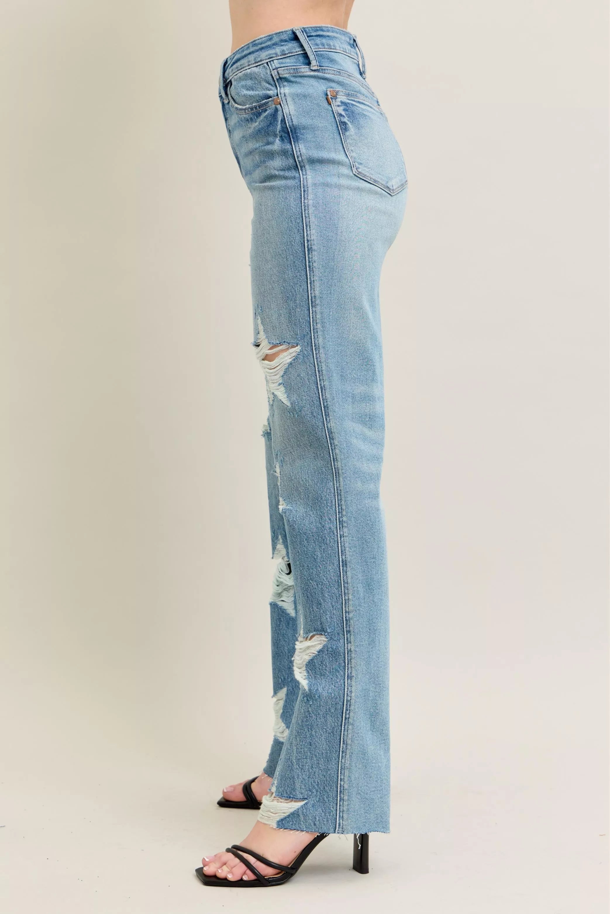 90s rigid distressed denim jeans, high-waisted straight fit, faded light blue, frayed leg details