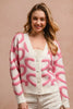 Pink and cream textured heart patterned buttoned v neck cardigan with cozy knit fabric.