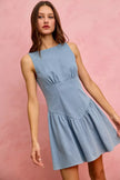 Light blue denim sleeveless mini dress with fitted waist and flared skirt.