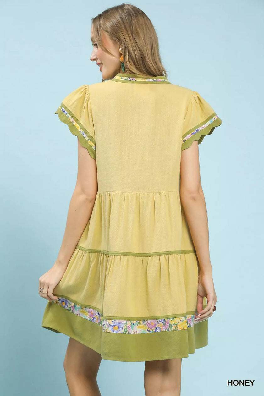 Lime green linen tiered dress with floral trim and flutter sleeves