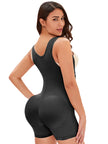 Side view of woman wearing black shaper highlighting waist shaping