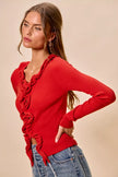 Vibrant red ribbed knit cardigan with cascading ruffles, fitted silhouette, denim pairing