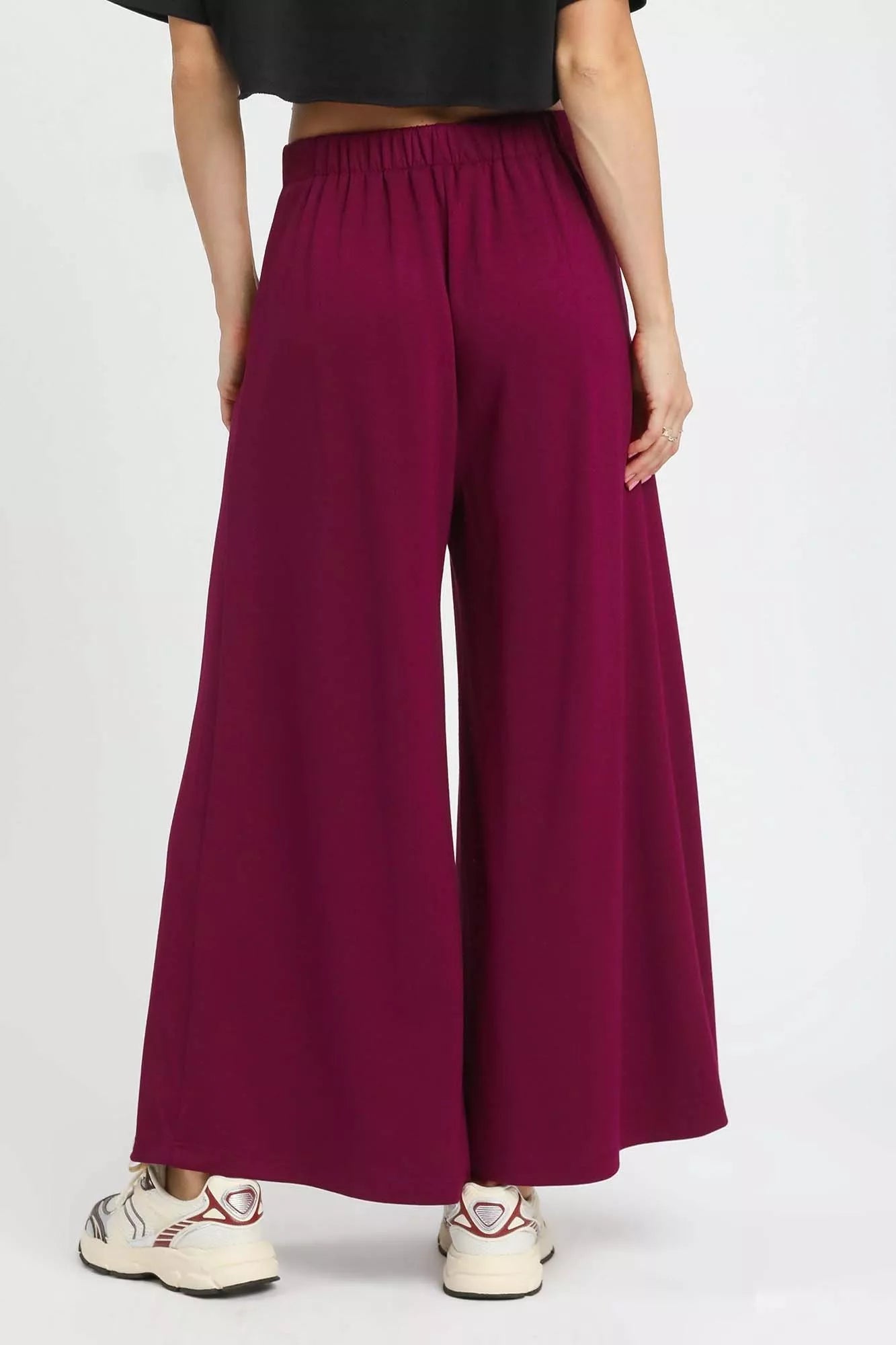 Merlot red wide-leg pants showcasing relaxed fit and elastic waistband
