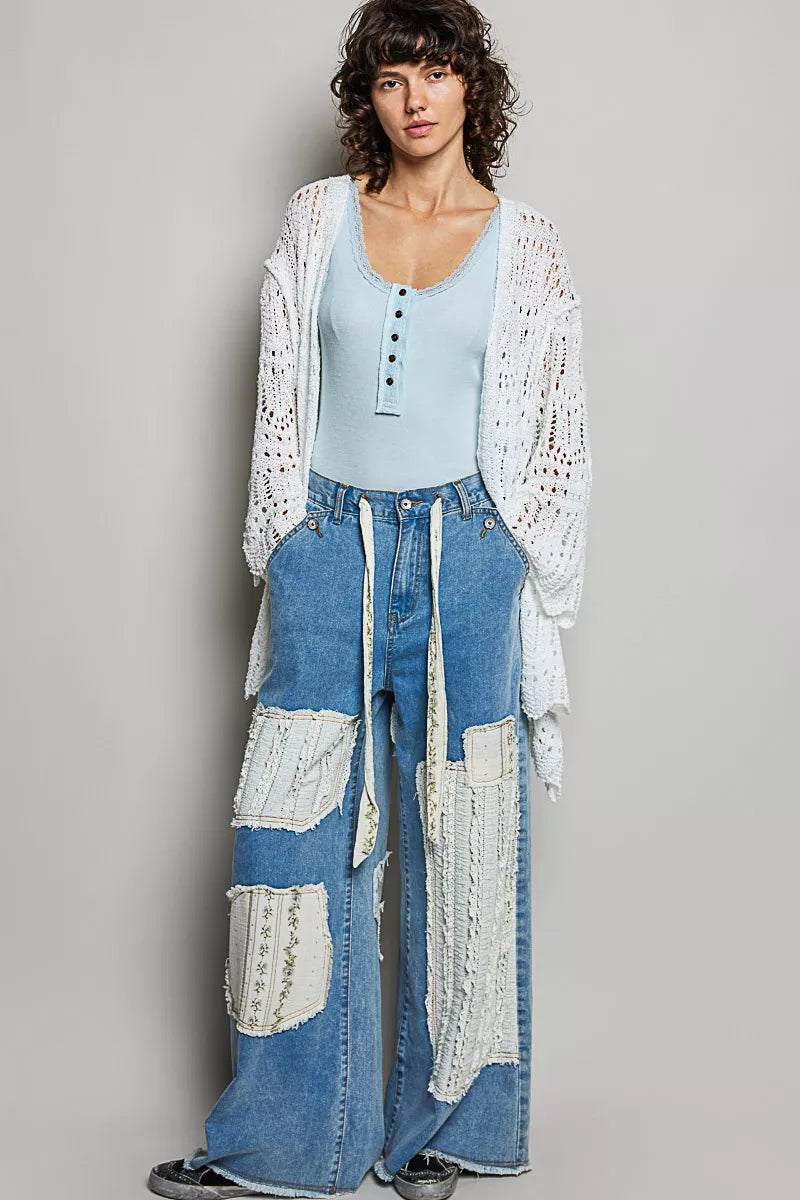 White openwork cardigan with scalloped edge, lightweight knit, loose fit, crochet texture.