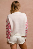 White textured cardigan with pink heart pattern, loose fit, chunky knit fabric, back view.