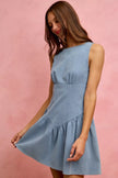 Light blue denim sleeveless mini dress with flared fit and tiered hem