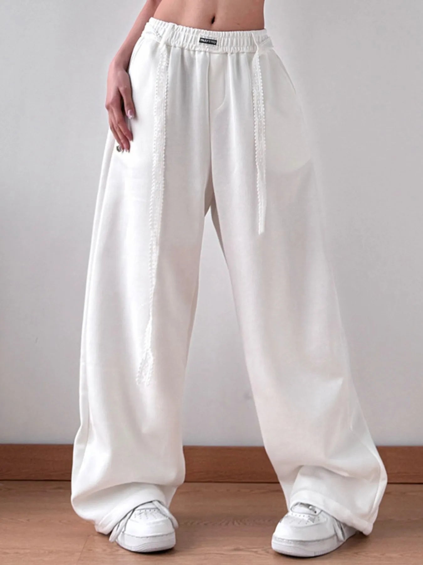 Side profile of oversized drawstring pants in motion