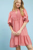 Pink smocked bib overlaid babydoll dress with lace ruffle details, flowy puff sleeves, and ruffled hem for boho-chic women’s wear.