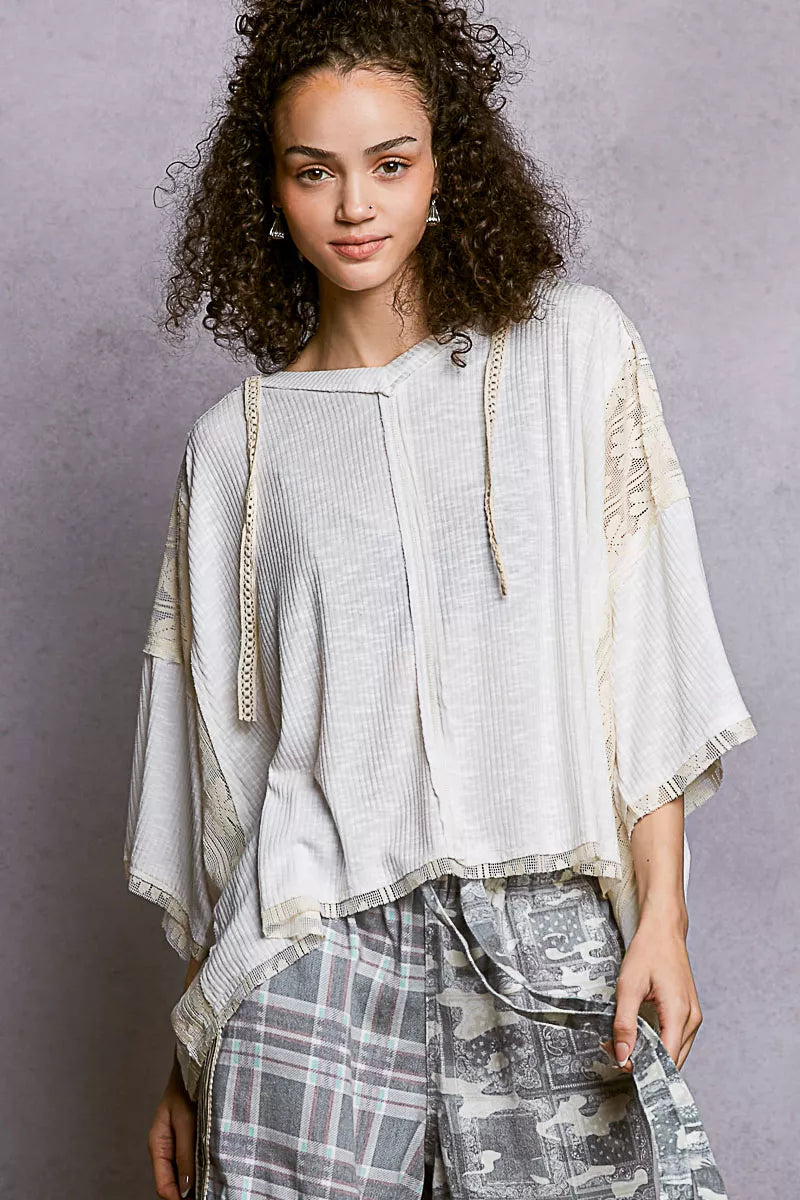 V-neck hoodie top with lace accents and exposed seams