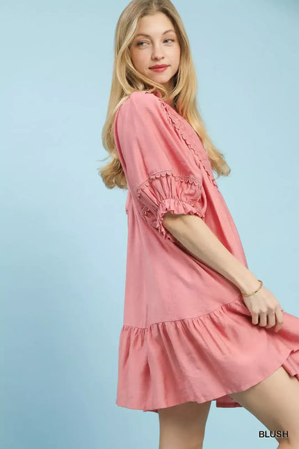 Soft pink boho babydoll dress with smocked sleeves and ruffled hem for flowy feminine fit