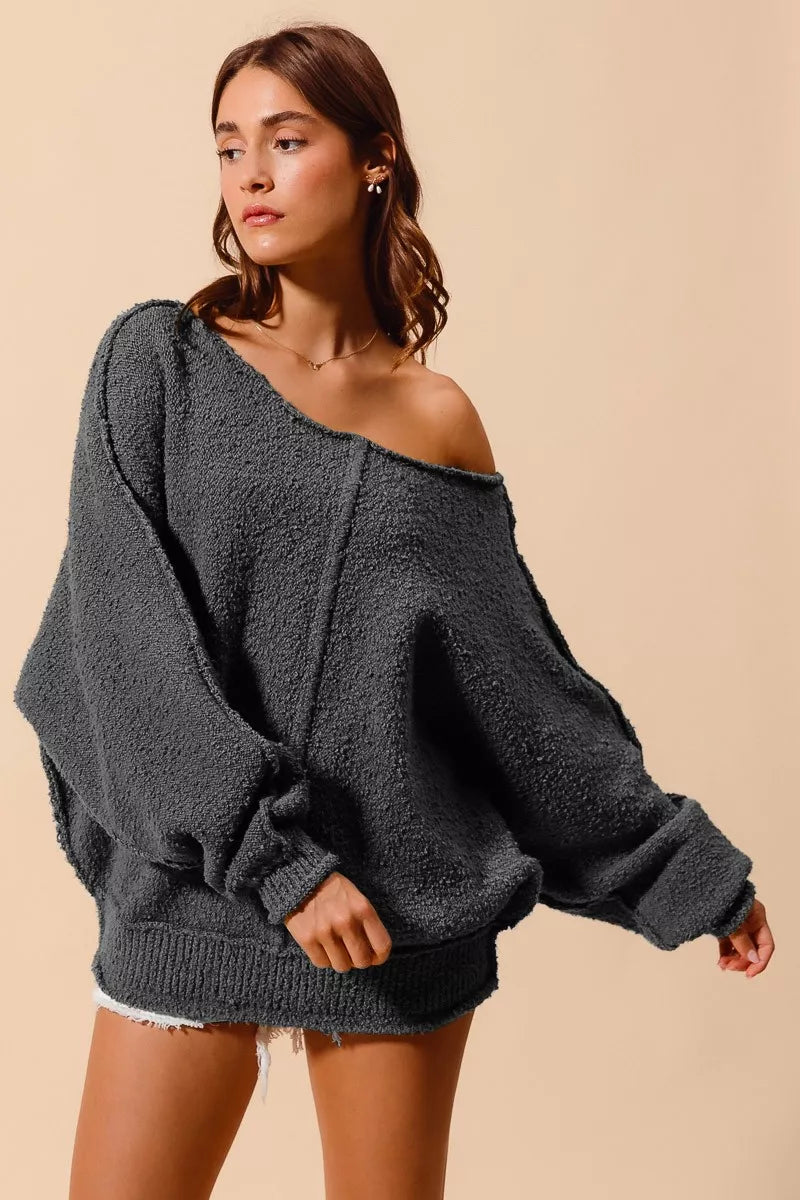 Charcoal grey slouchy boucle sweater with exposed seam details