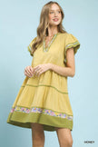 Yellow linen dress with green trim and floral accents, tiered fit, flutter sleeves, V-neckline