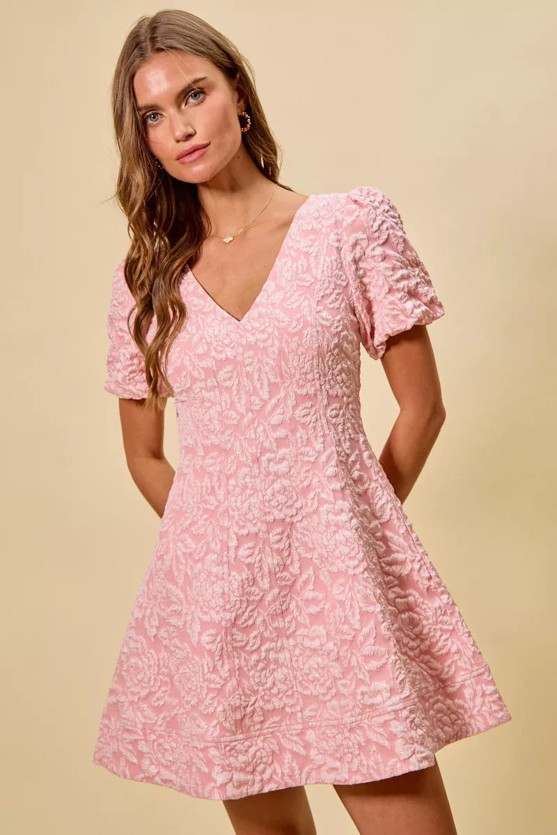 Floral jacquard mini dress displayed on a hanger with flared silhouette