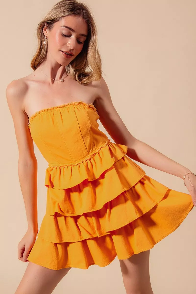 Strapless ruffled mini dress in Sunset Gold with smocked bodice