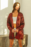 Shimmering red metallic knit v-neck open cardigan with loose fit and textured fabric.
