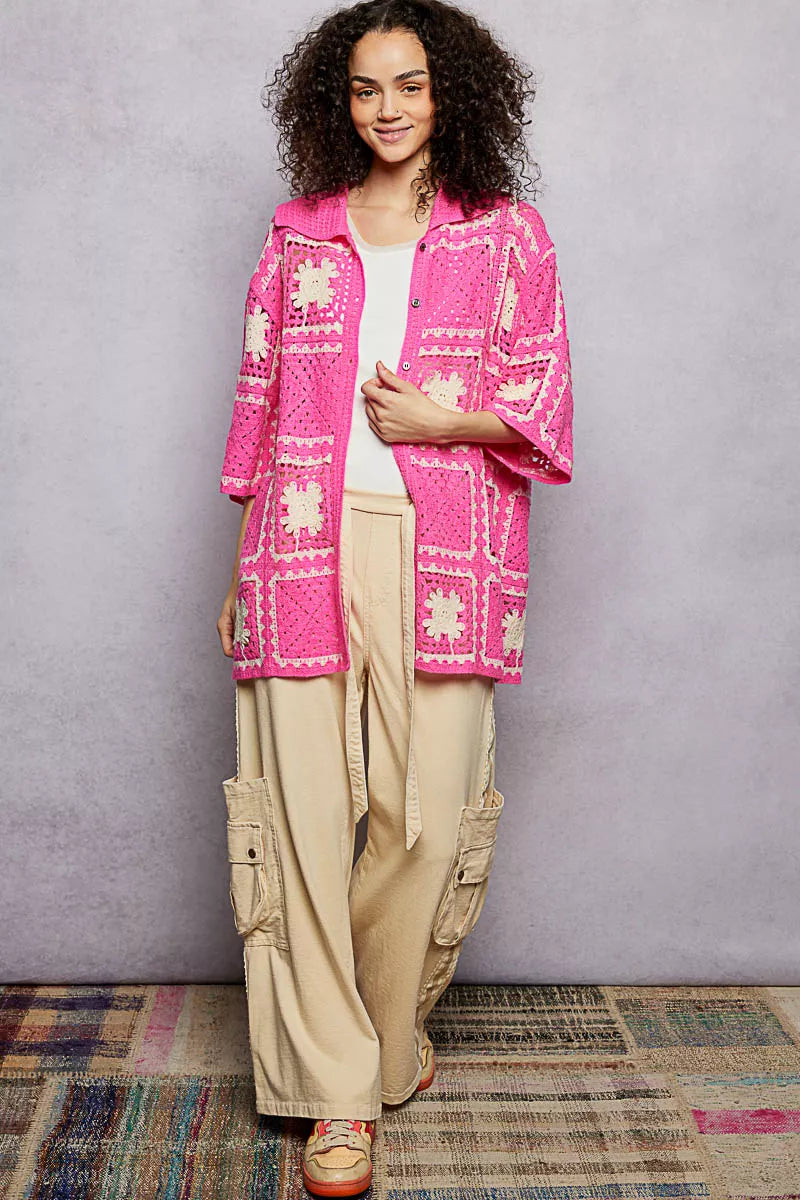 Short-sleeve crochet shirt displaying detailed openwork floral design and button closure