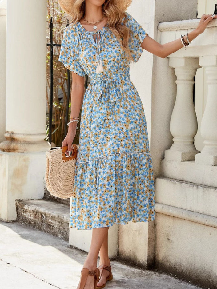 Blue floral ruffle hem midi dress with tie front and short sleeves.