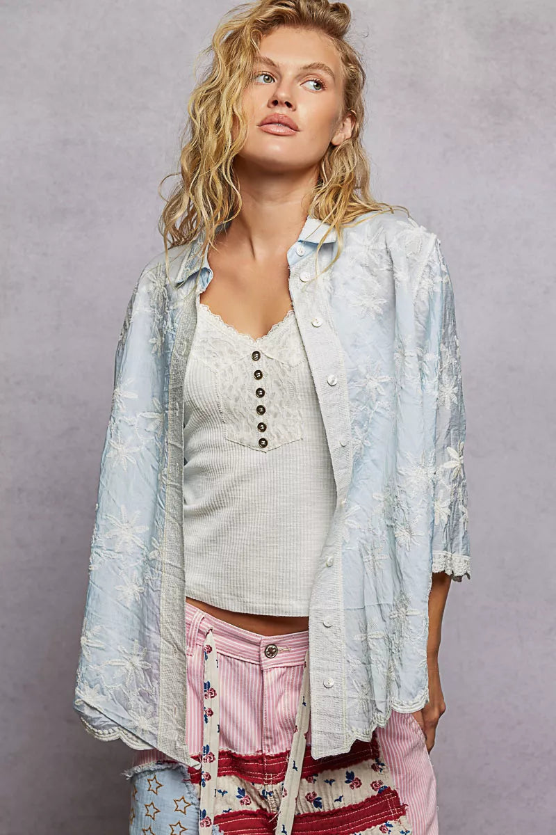 Close-up of delicate floral embroidery on a relaxed-fit shirt