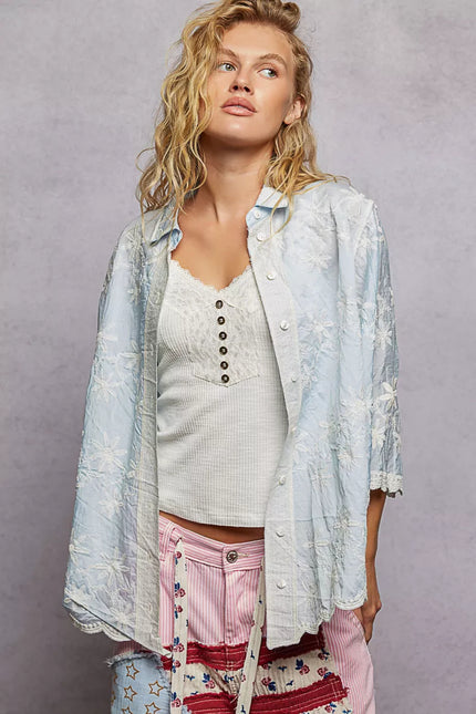 Close-up of delicate floral embroidery on a relaxed-fit shirt