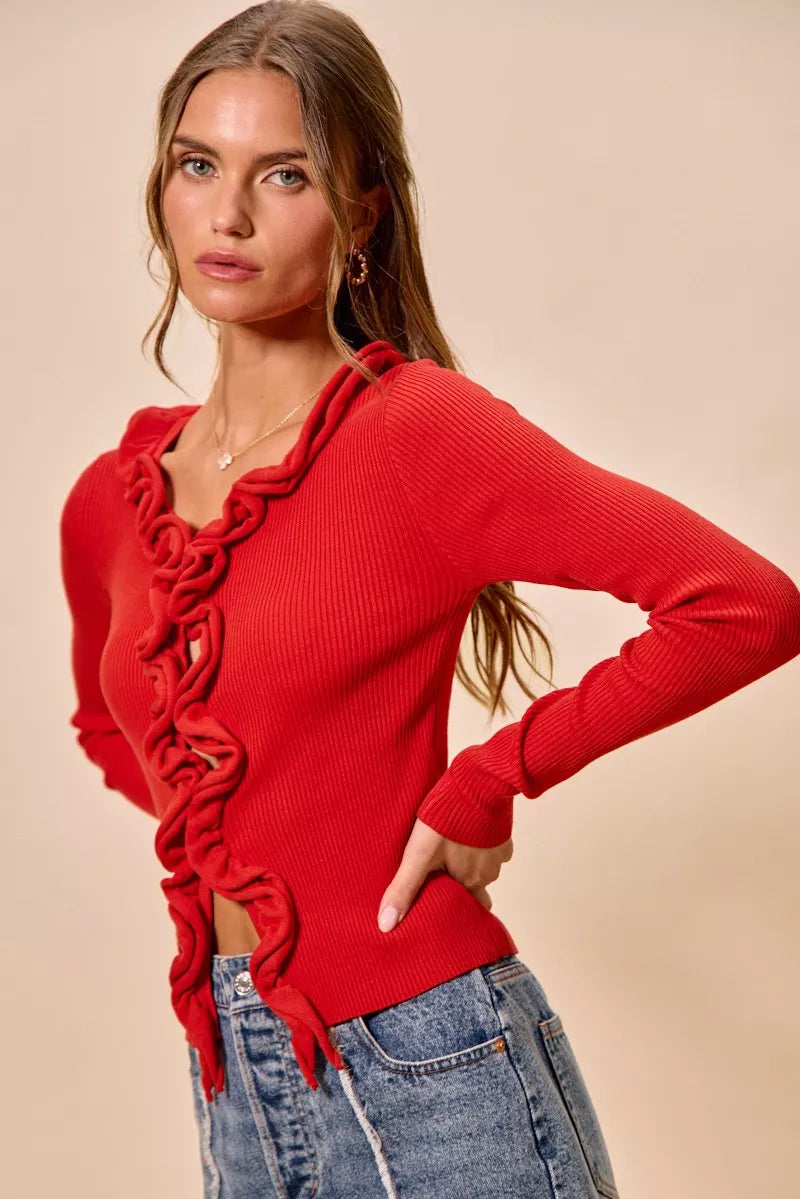 Vibrant red ribbed knit cardigan with cascading ruffles, fitted silhouette, and textured fabric.