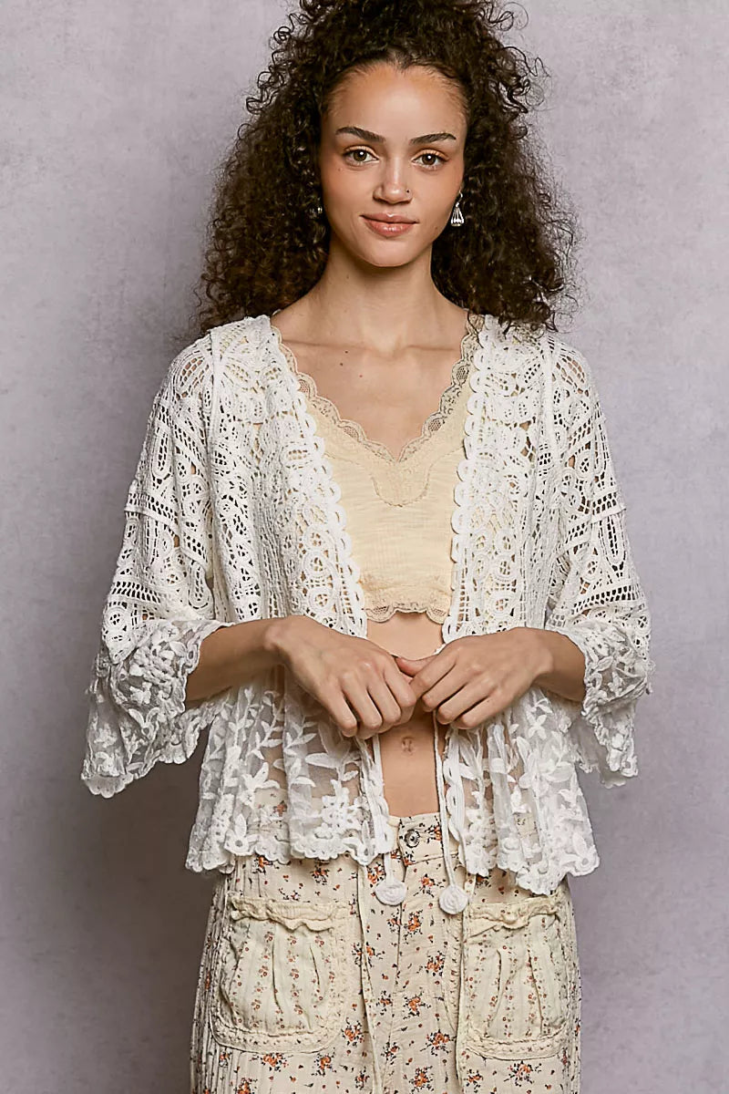 Soft ivory floral lace crochet cardigan with tassel detail