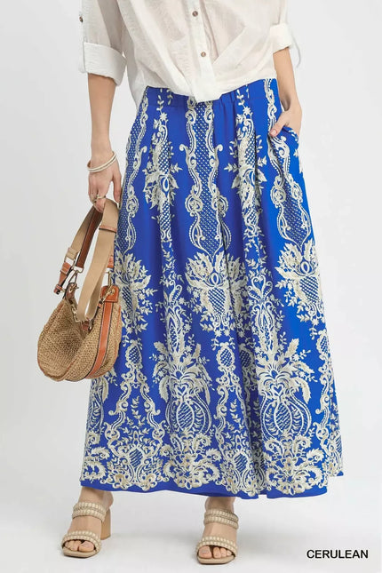 Flowy blue embroidered wide-leg pants with intricate floral patterns and sheer detailing.