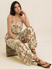 Cream base jumpsuit with brown floral print, wide leg, smocked bodice, tie straps