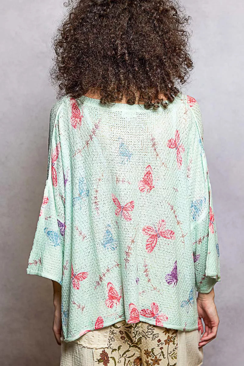 Mint green butterfly-printed sweater top with half sleeves and ribbed neck