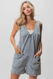 Light-wash denim shortall with patch pockets and relaxed fit.