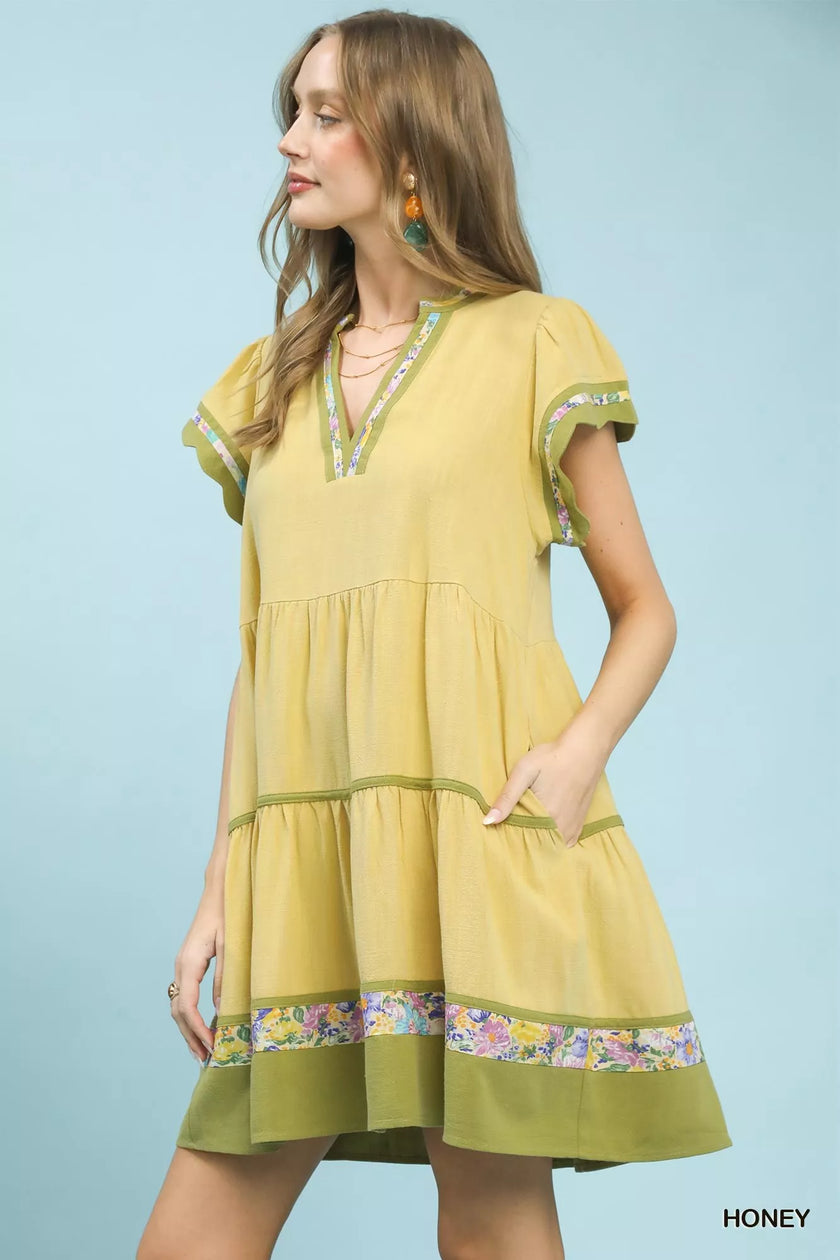 Linen tiered dress in honey yellow with floral trim and flutter sleeves