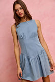 Light blue denim sleeveless mini dress with fitted waist and flared skirt.