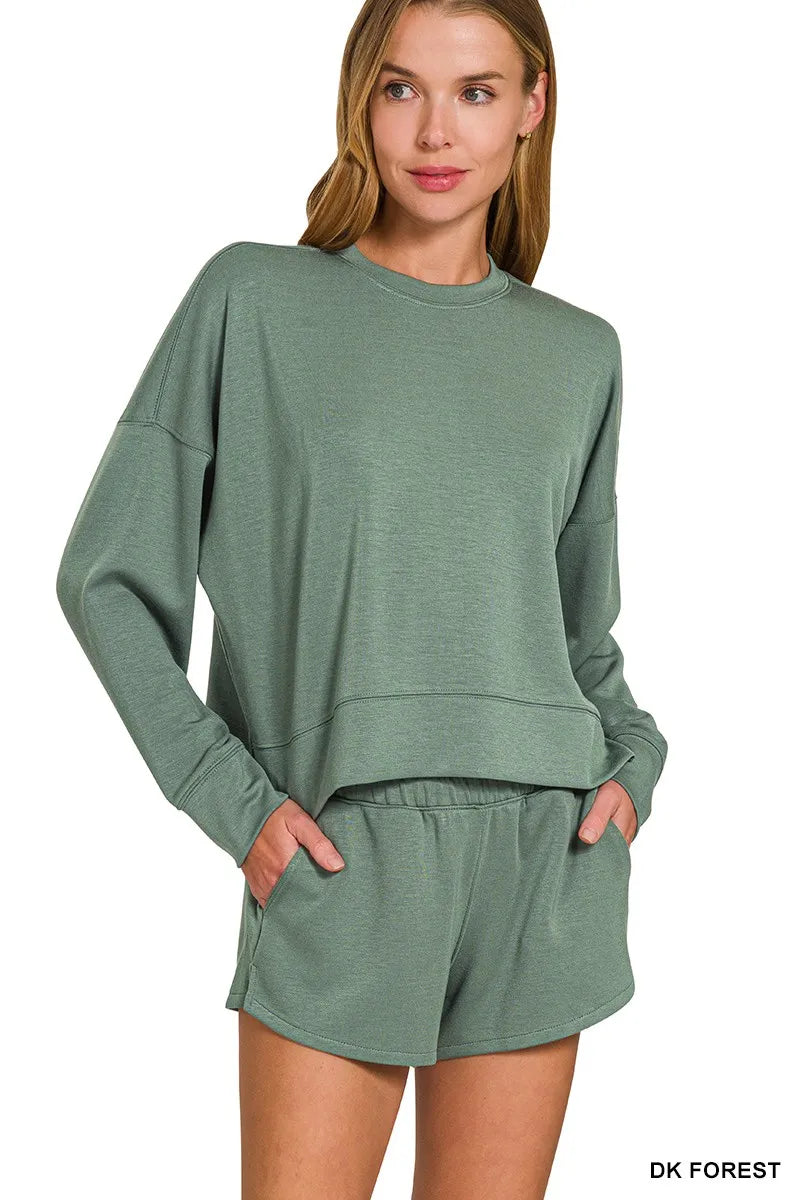 Close-up of pocketed scuba sweatshirt with matching forest green shorts