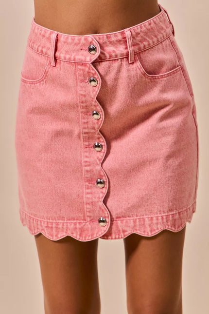 Pink vintage wash denim mini skirt with scalloped hem and front button closure