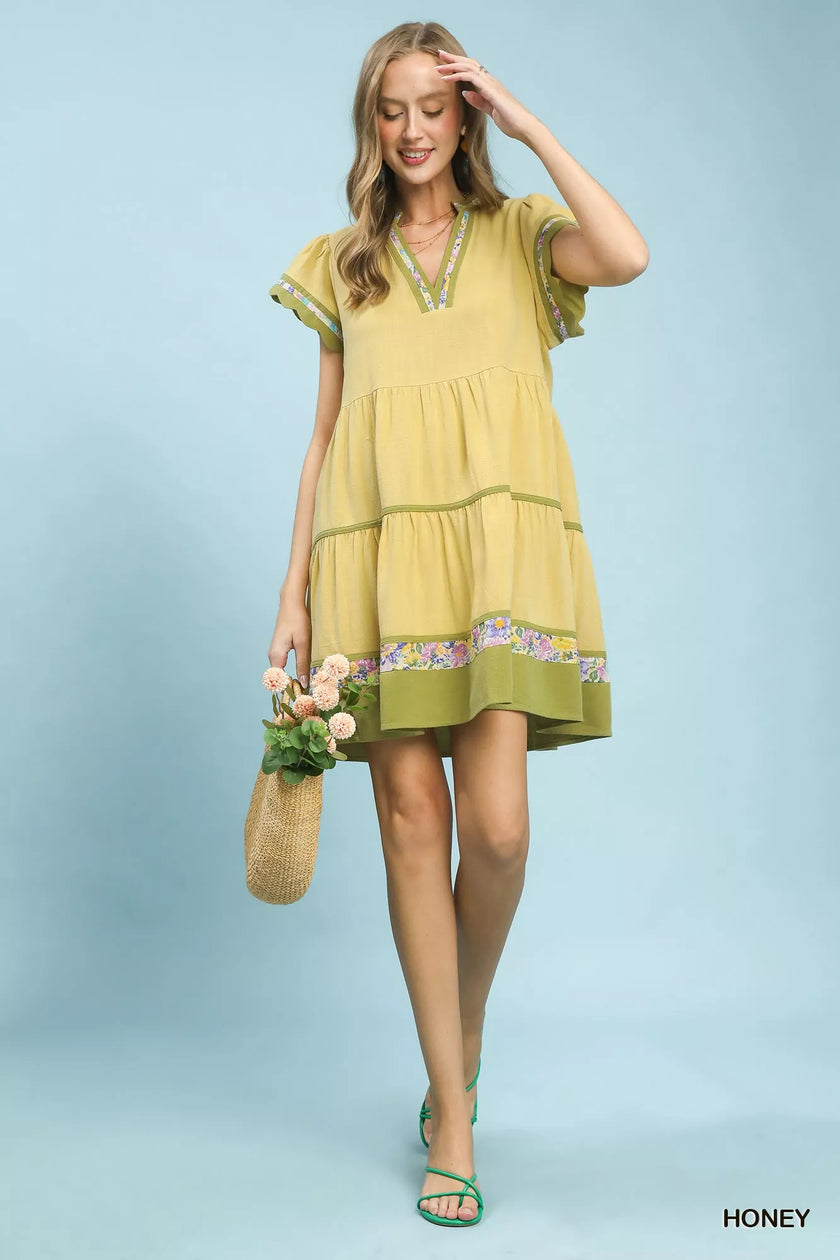 Lime green linen tiered dress with floral trim and flutter sleeves, flowy fit