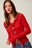 Red ribbed knit cardigan with cascading ruffles, fitted silhouette, long sleeves.