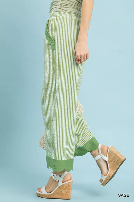 Close-up of scalloped hem on lightweight wide-leg pants