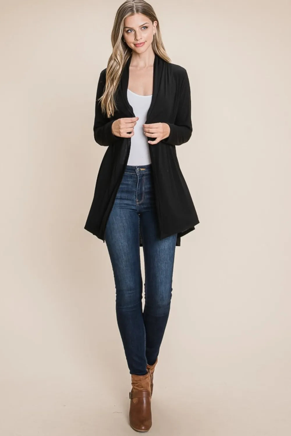 Open-front cardigan draped over arm in charcoal black