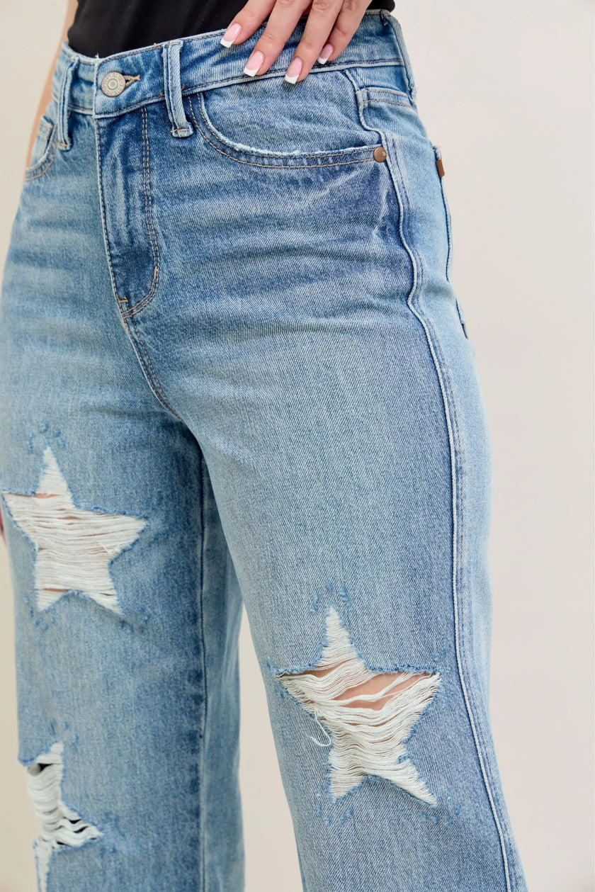 **High-waisted straight-leg plus jeans: rigid magic-washed light blue denim with star-shaped distressed rips.**