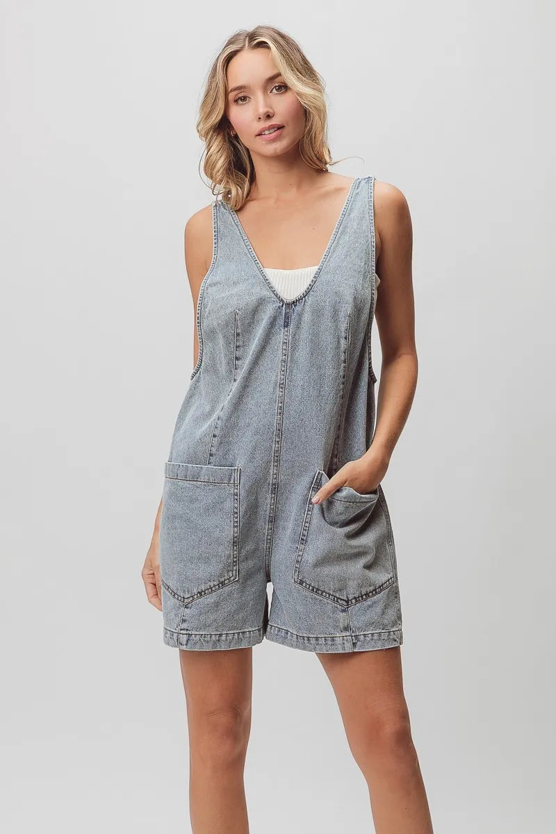 Light-washed denim shortall with patch pockets and relaxed fit.