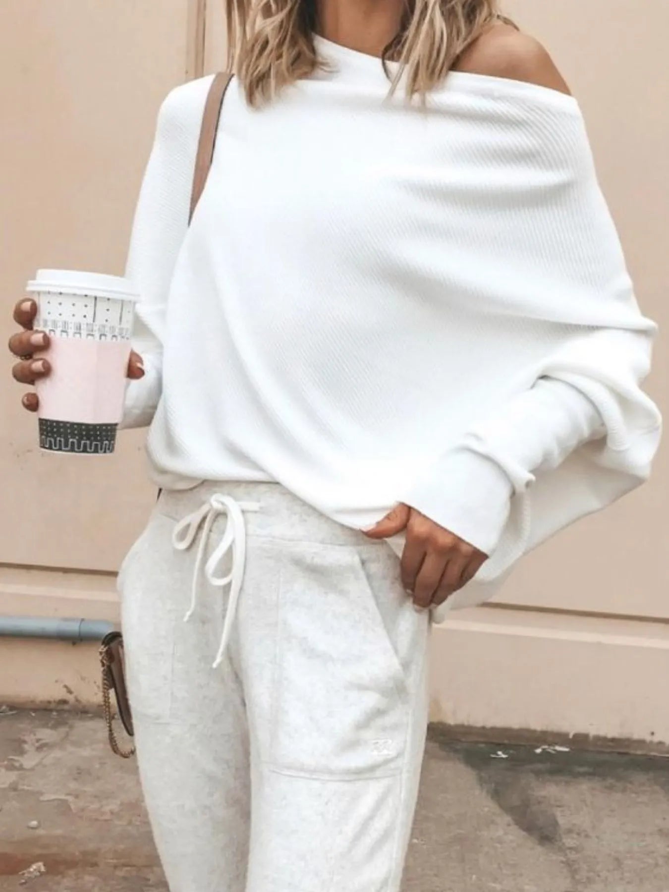 Off-shoulder ribbed knit top highlighting relaxed fit and fabric stretch