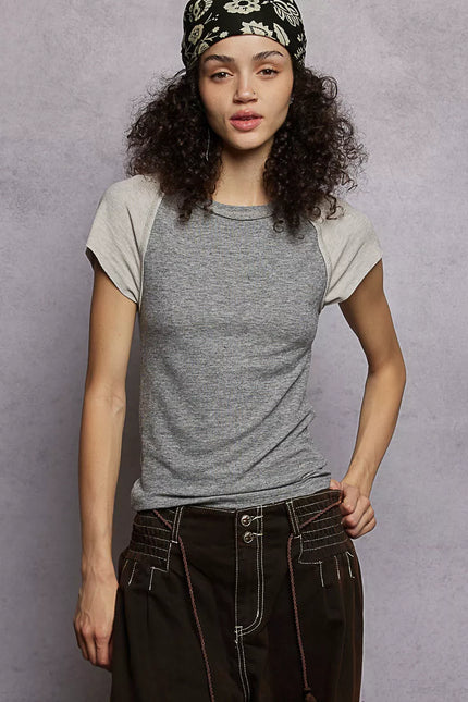 Close-up of fitted T-shirt showing ribbed neckline and contrast sleeve trim