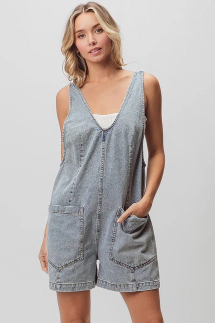 Light-wash denim shortall with patch pockets, relaxed fit, textured fabric, vintage wash.