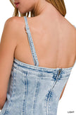 Light-wash denim dress with spaghetti straps and exposed seam detailing at back