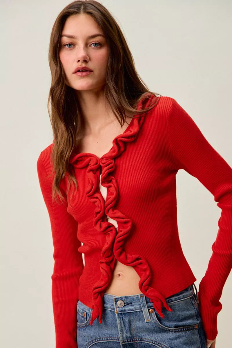 Red ribbed sweater with cascading ruffles, fitted silhouette, denim pair