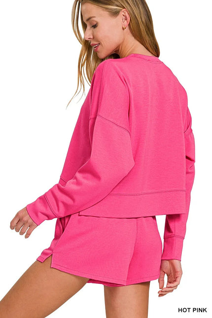 Close-up of long-sleeve scuba sweatshirt with pocket detail