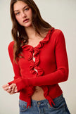 Red ribbed cardigan with ruffle detailing, cropped fit, denim pairing