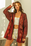 Red metallic knit V-neck cardigan with shimmering texture, loose fit, open front style.